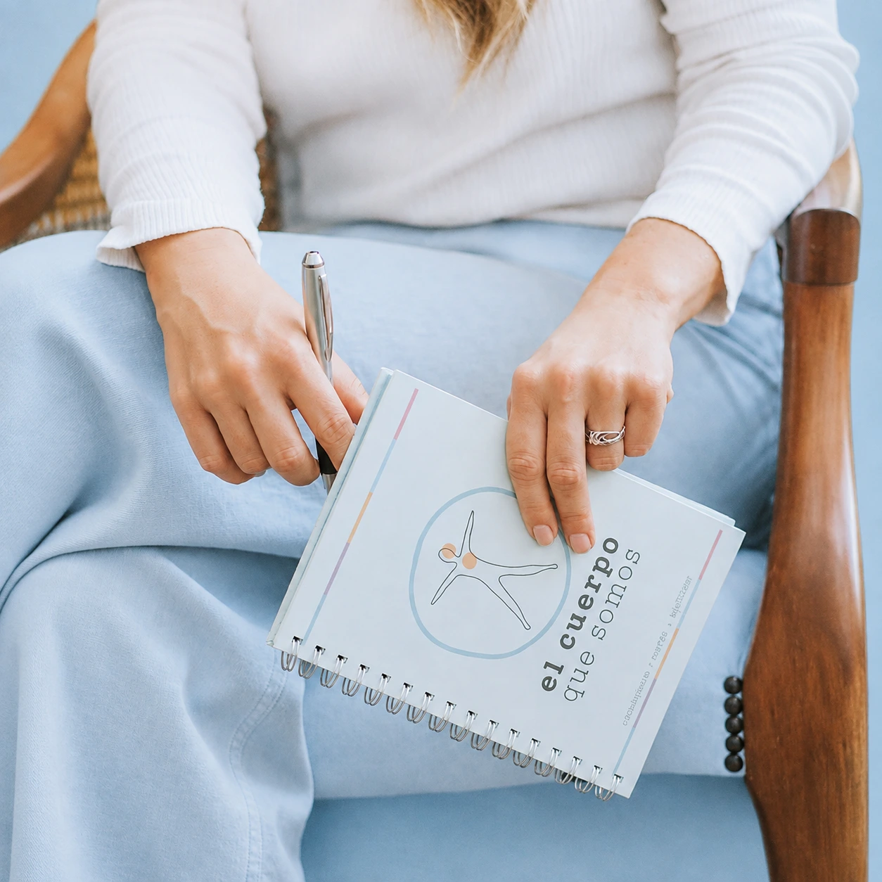 El cuaderno de trabajo de El Cuerpo Que Somos sobre las piernas de una participante